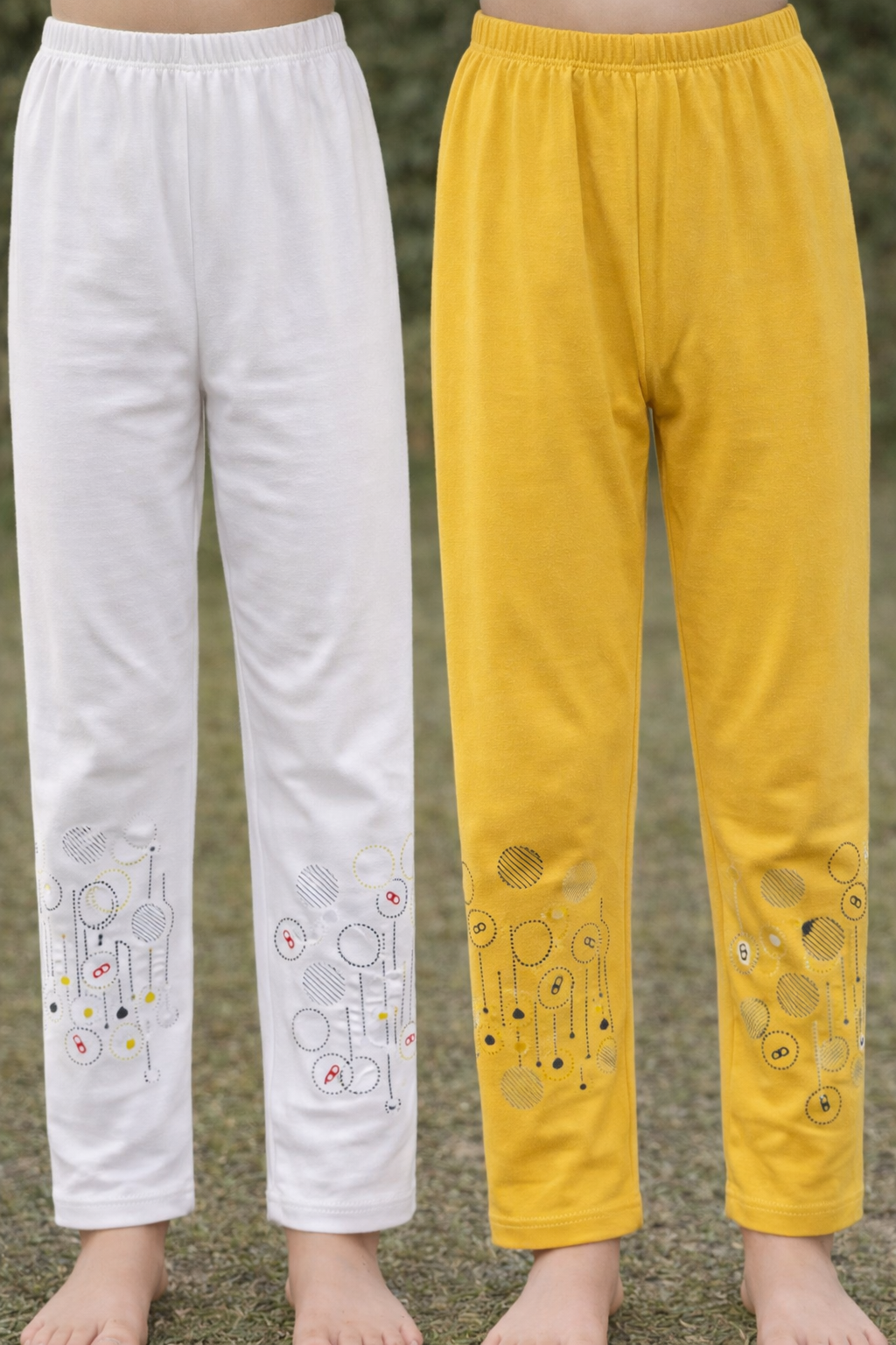 White and yellow pants with cartoon designs on a natural background
