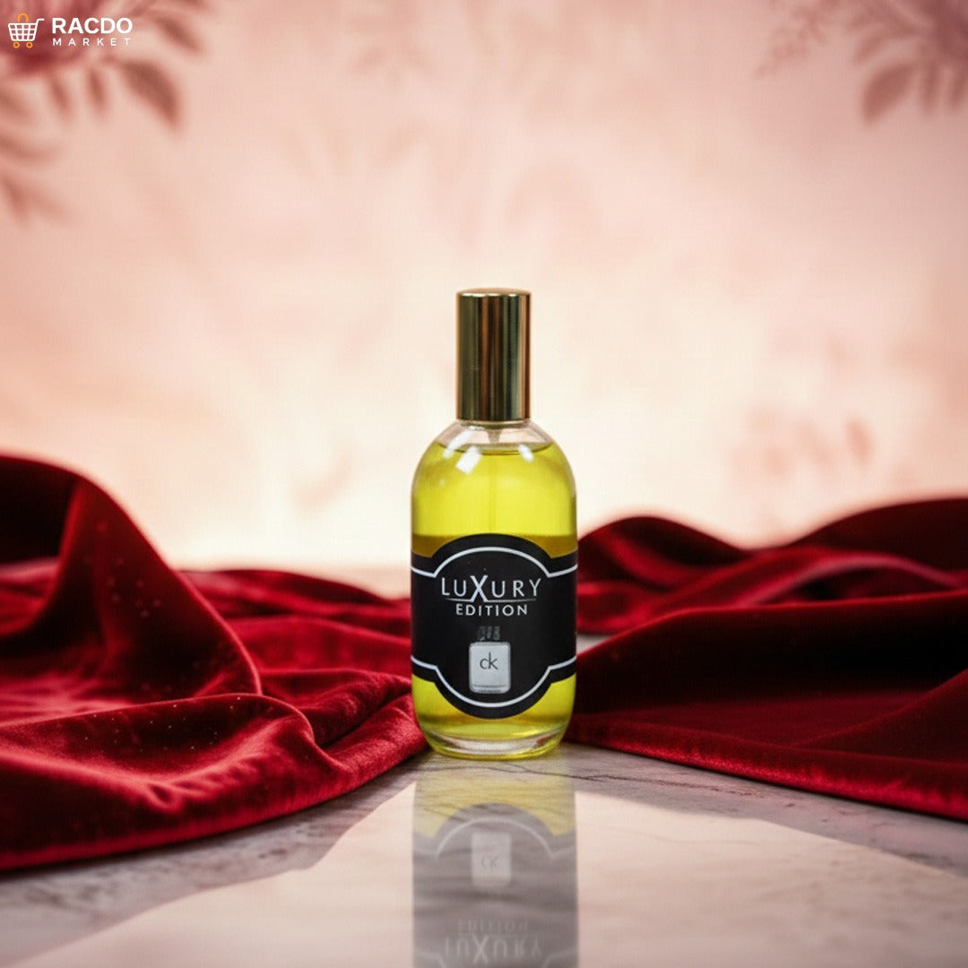 Perfume bottle labeled 'Luxury Edition' on a reflective surface with red fabric in the background