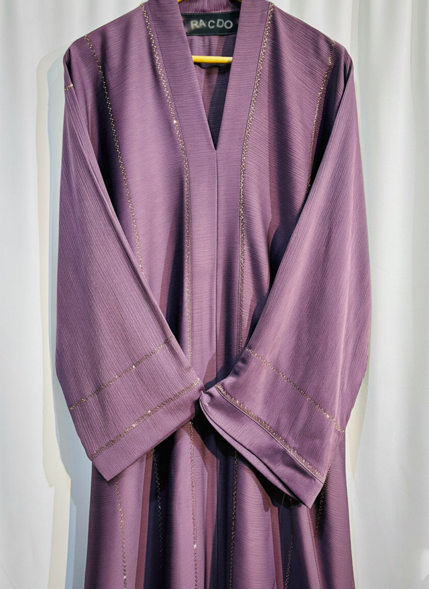 Purple abaya with gold embroidery on a white background

