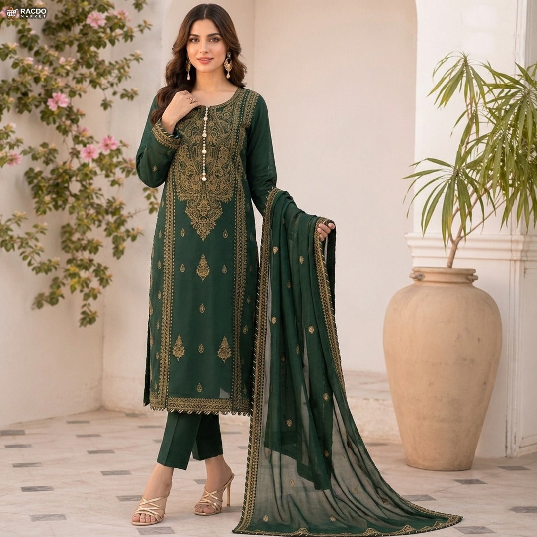 Woman in a green embroidered outfit standing in a decorated room with plants.

