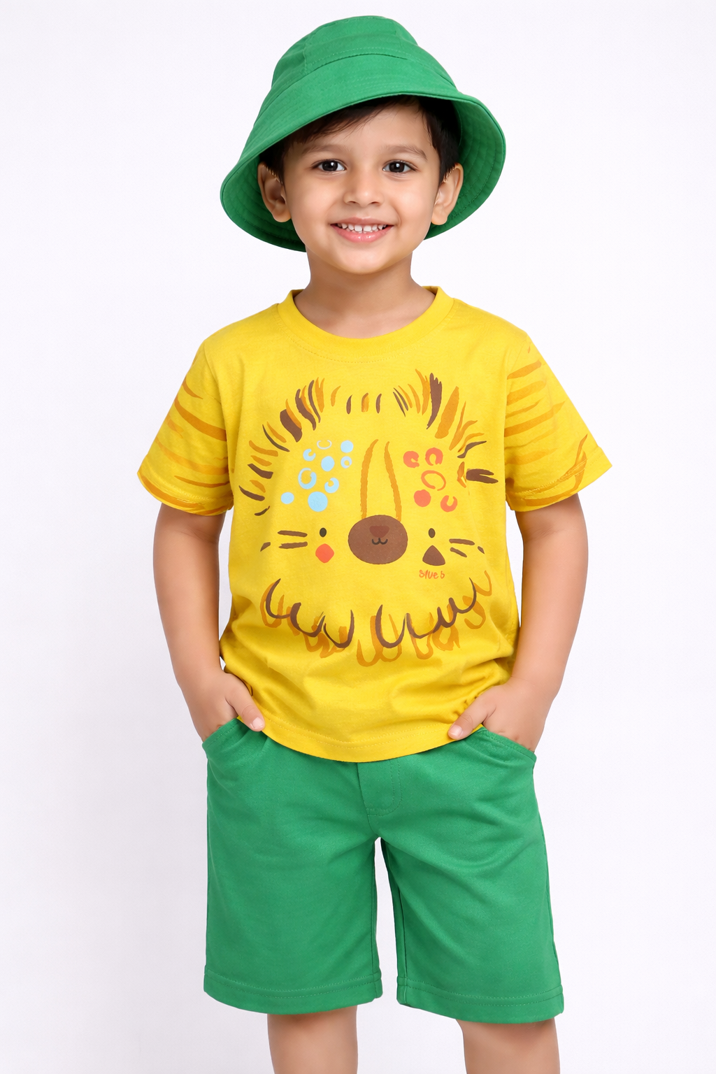 Child wearing a yellow t-shirt with a lion design and green shorts and hat on a white background

