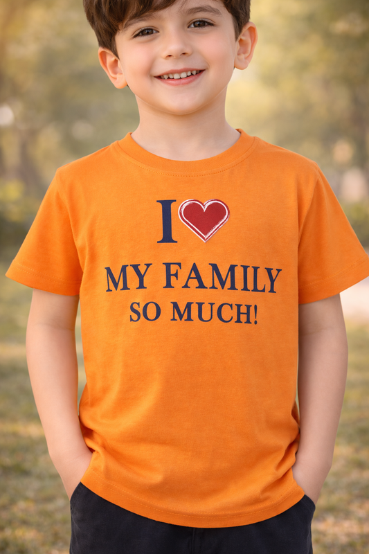 Child wearing an orange t-shirt with 'I love my family so much!' text outdoors.

