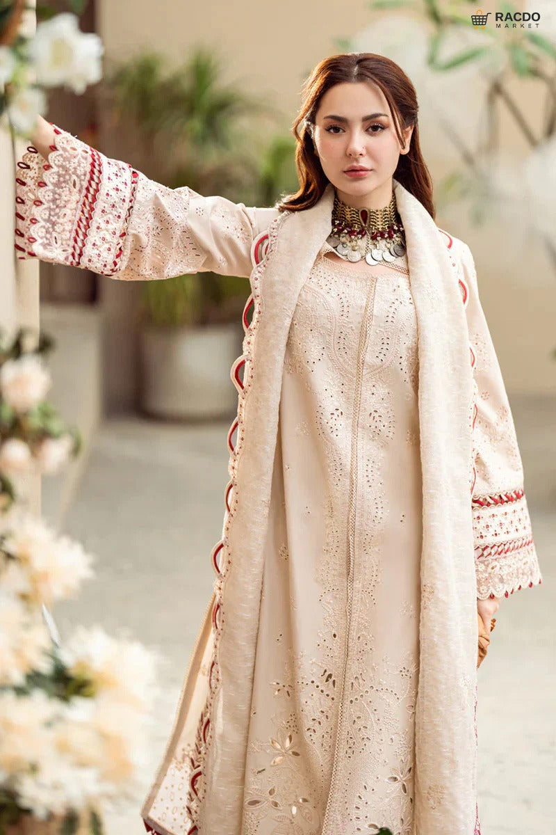 Woman wearing a traditional outfit with intricate patterns in an outdoor setting.

