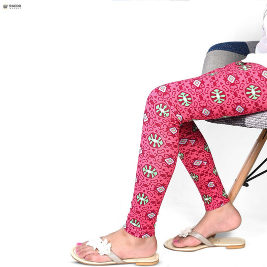 Person wearing pink patterned leggings sitting on a chair with a white background

