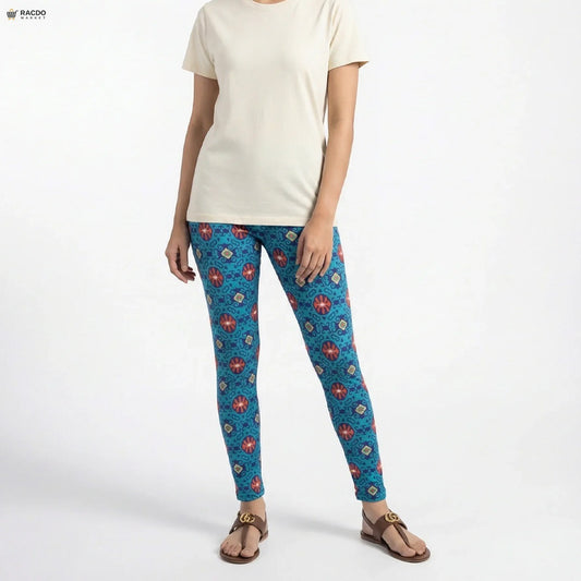 Person wearing blue patterned leggings and a white shirt on a white background