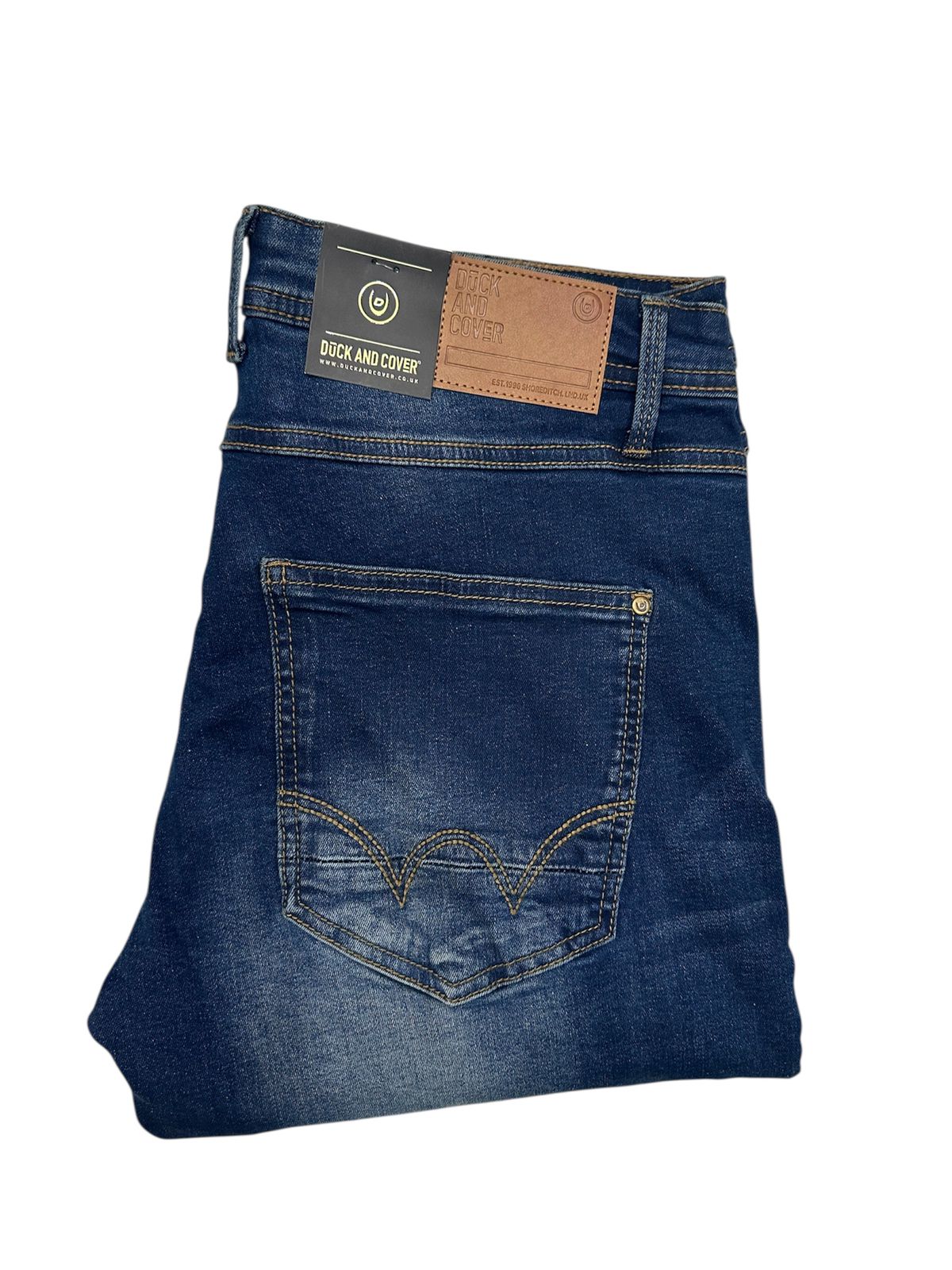 Folded pair of blue jeans with a brand label on a white background

