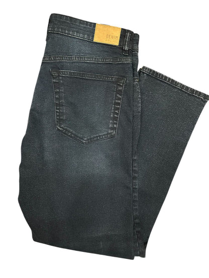 Folded pair of black jeans on a white background

