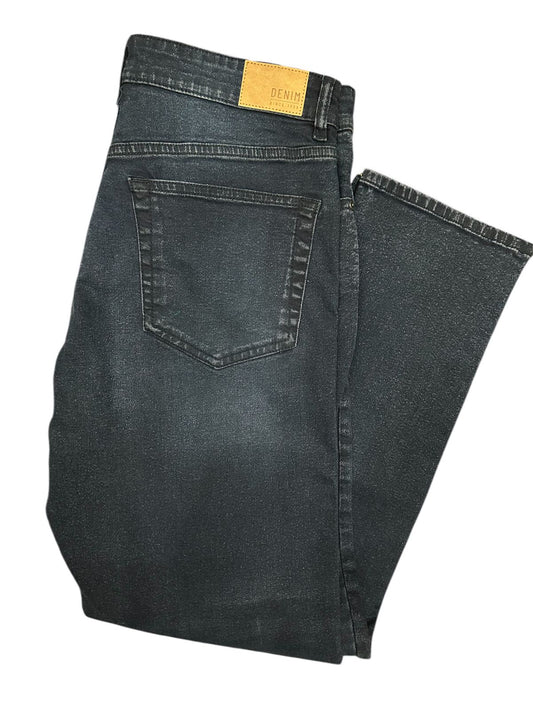 Folded pair of black jeans on a white background

