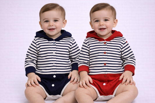Two children wearing matching striped outfits on a white background

