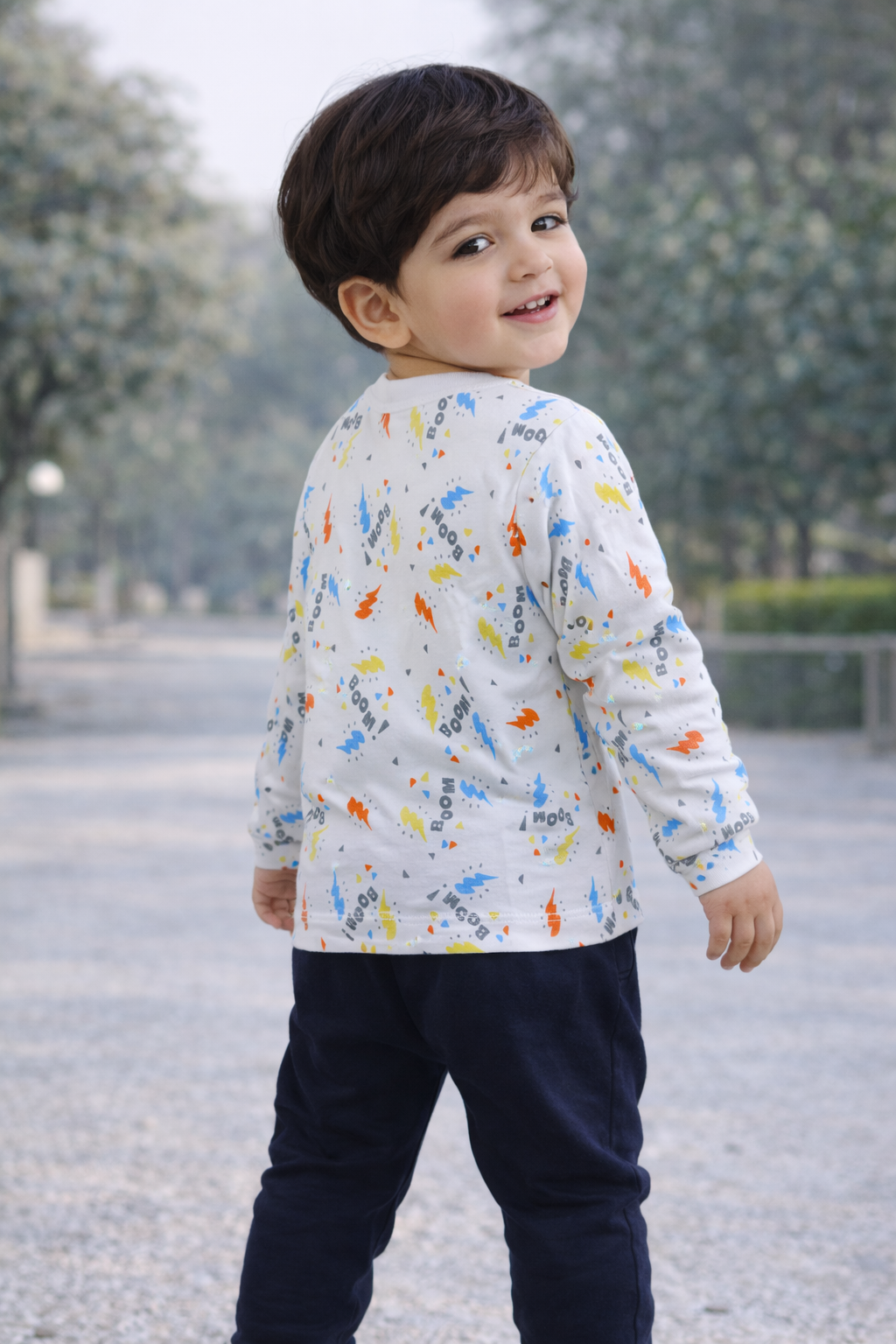 Child wearing a colorful shirt with a pattern outdoors

