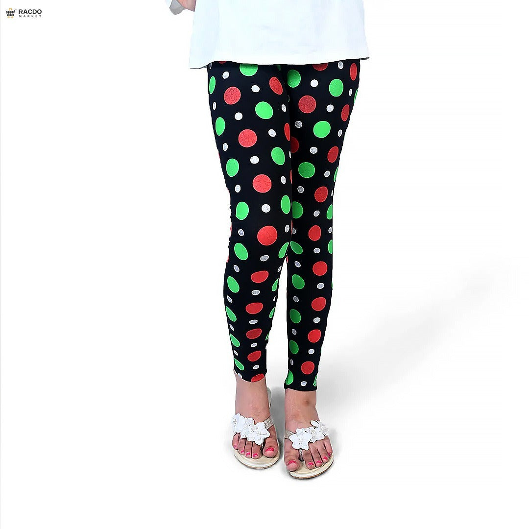 Black leggings with red and green polka dots worn by a person on a white background