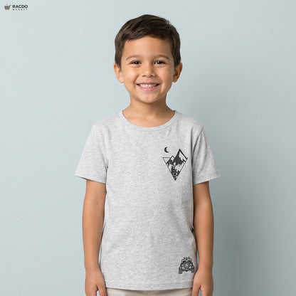 Child wearing a gray t-shirt with a graphic design on a light gray background