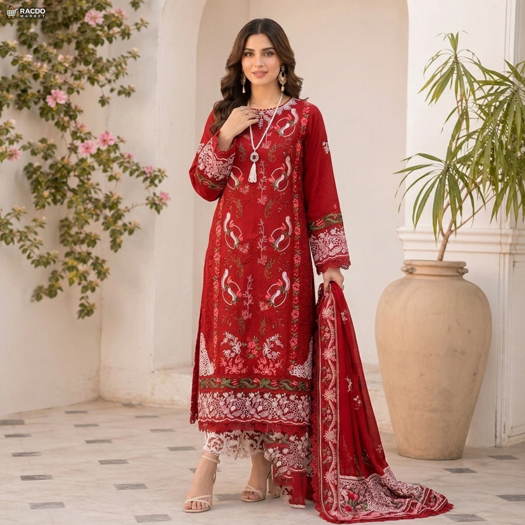 Woman wearing a red embroidered traditional outfit in an elegant indoor setting.


