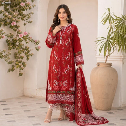 Woman wearing a red embroidered traditional outfit in an elegant indoor setting.

