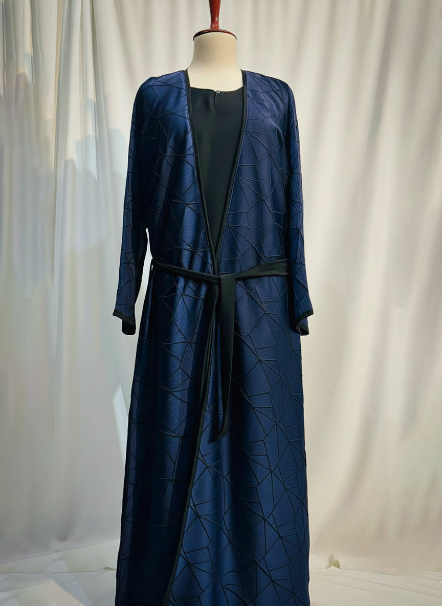 Navy blue dress with matching jacket on a mannequin against a white curtain background