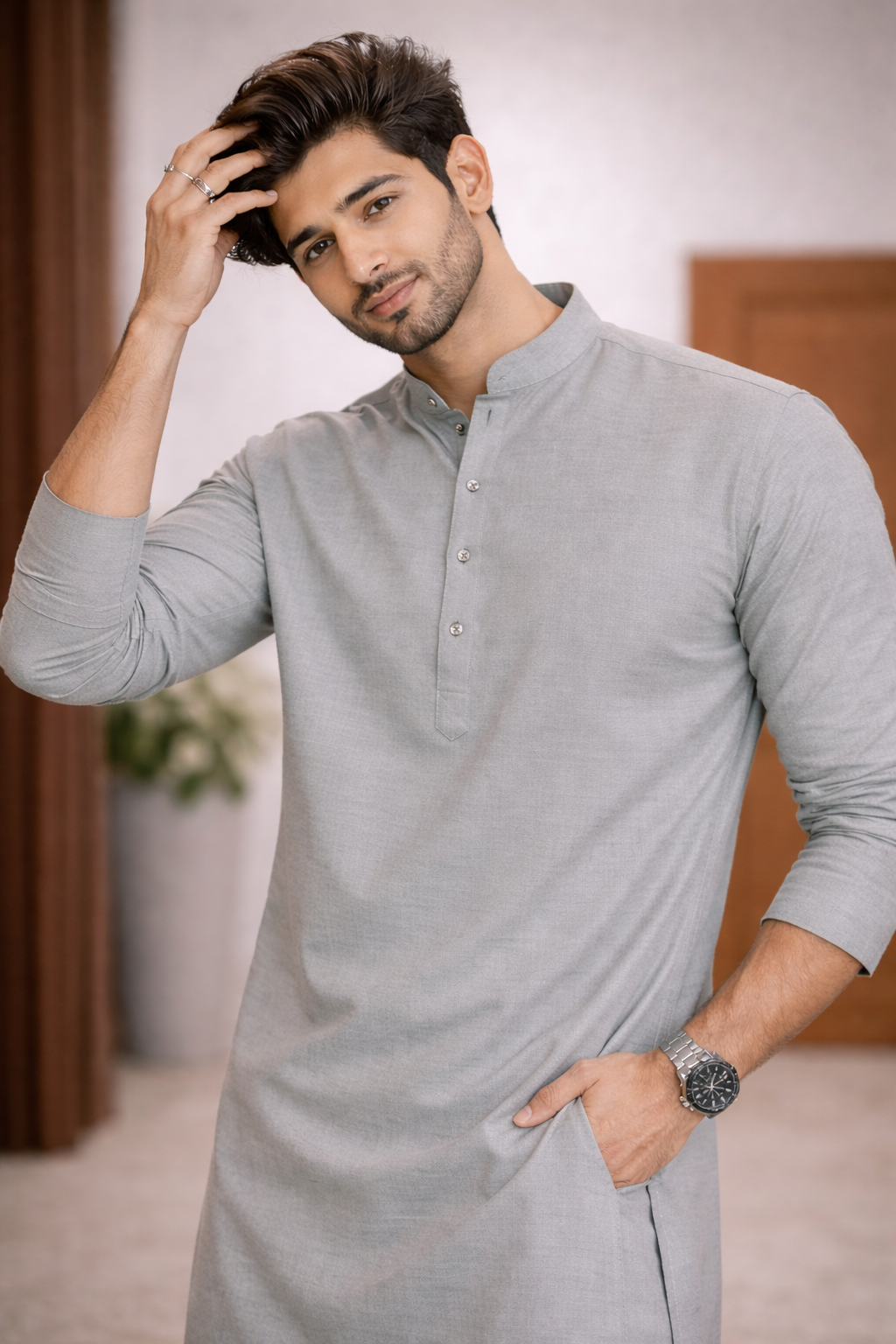 Man wearing a gray kurta with a neutral background

