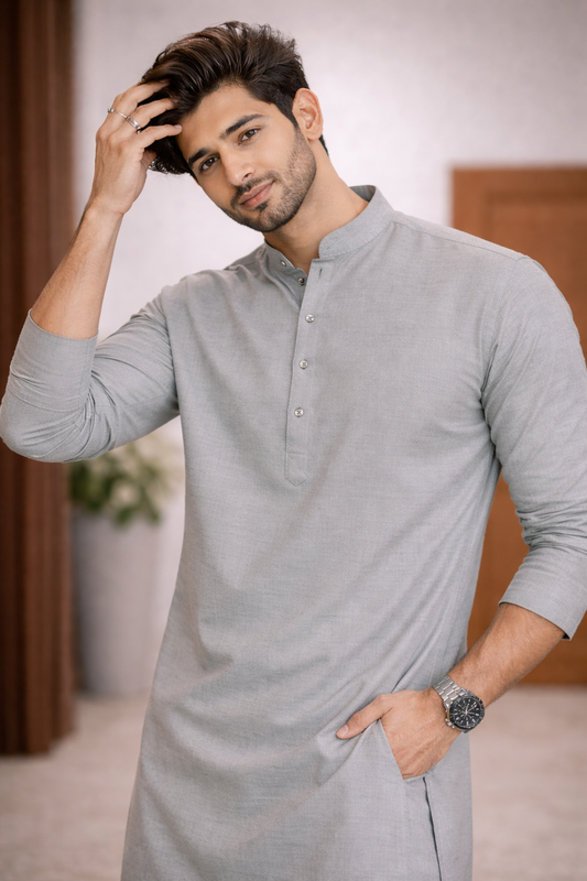 Man wearing a gray kurta with a neutral background

